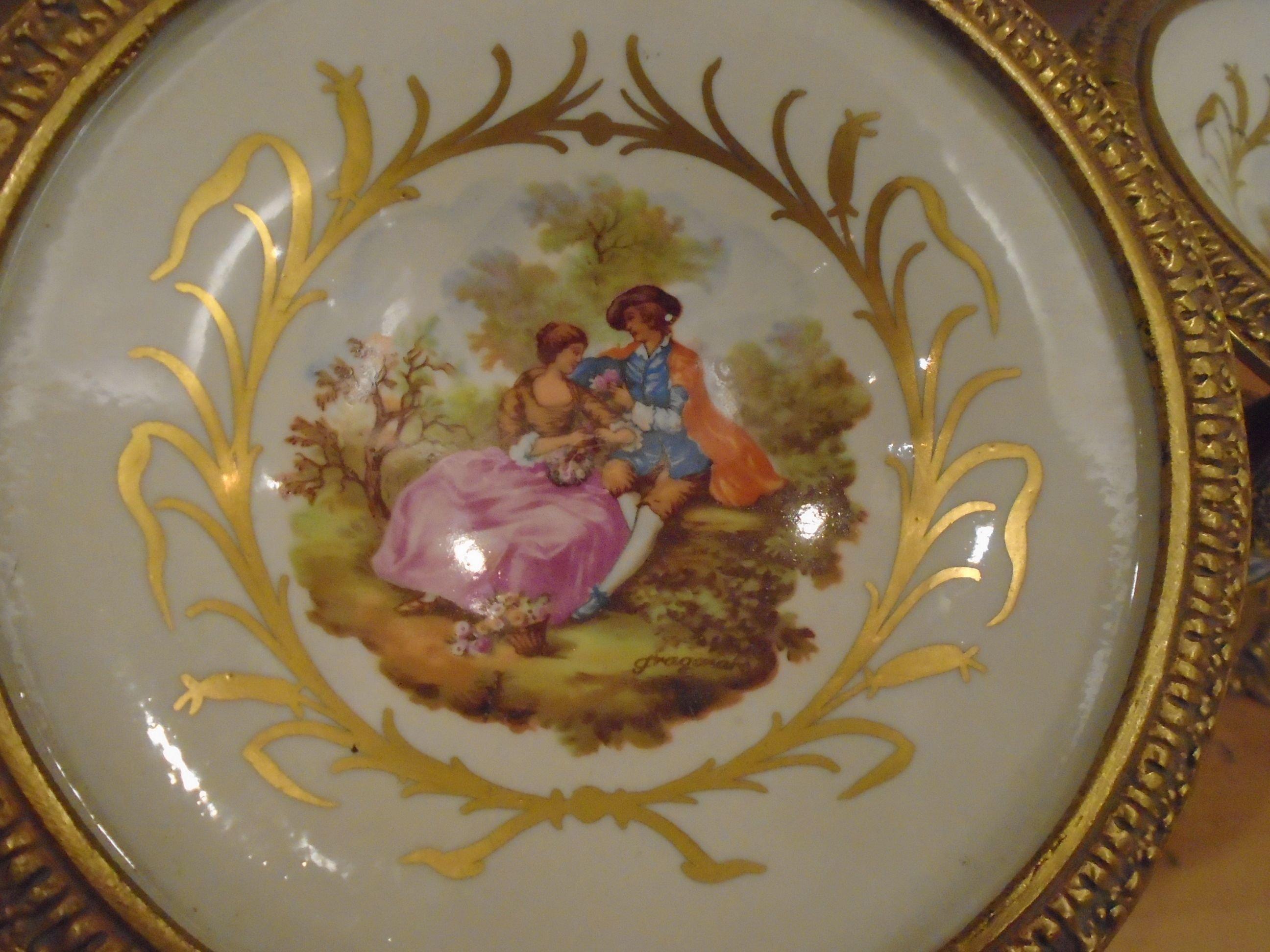 Pair of Fragonard porcelain pedestal plates, man and woman motif.
