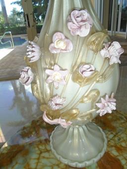 Glass base table lamp with pink glass flower decoration.