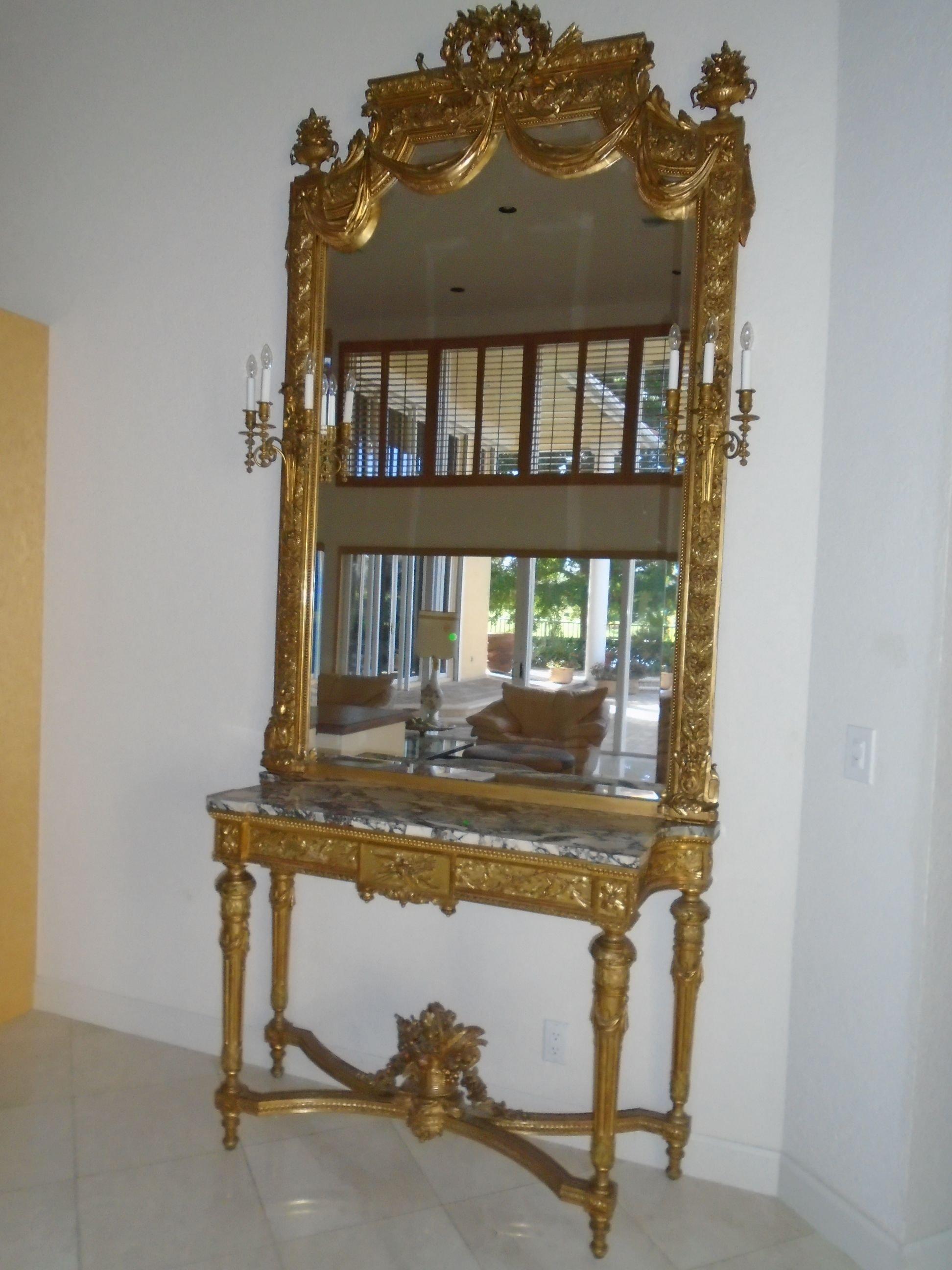 Grand entrance mirror & console with a marble top and gold frame.