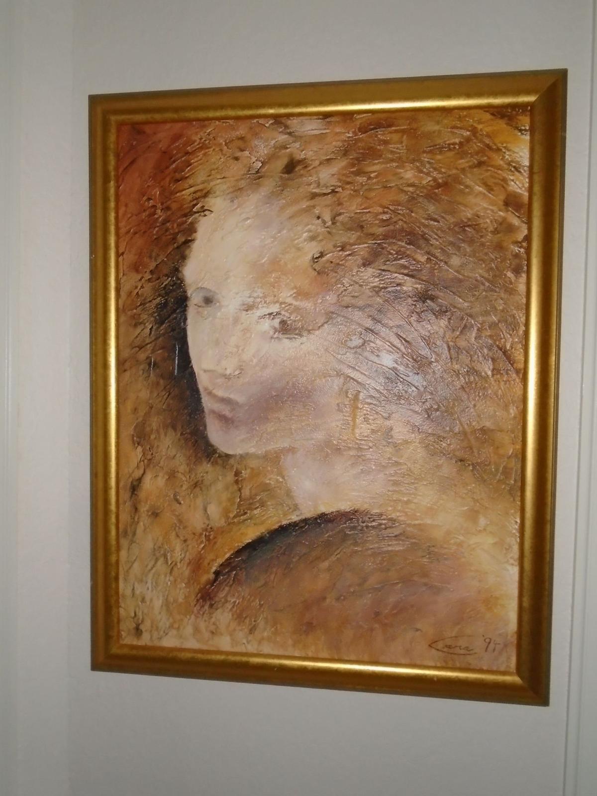 Painting of woman in a gold frame.