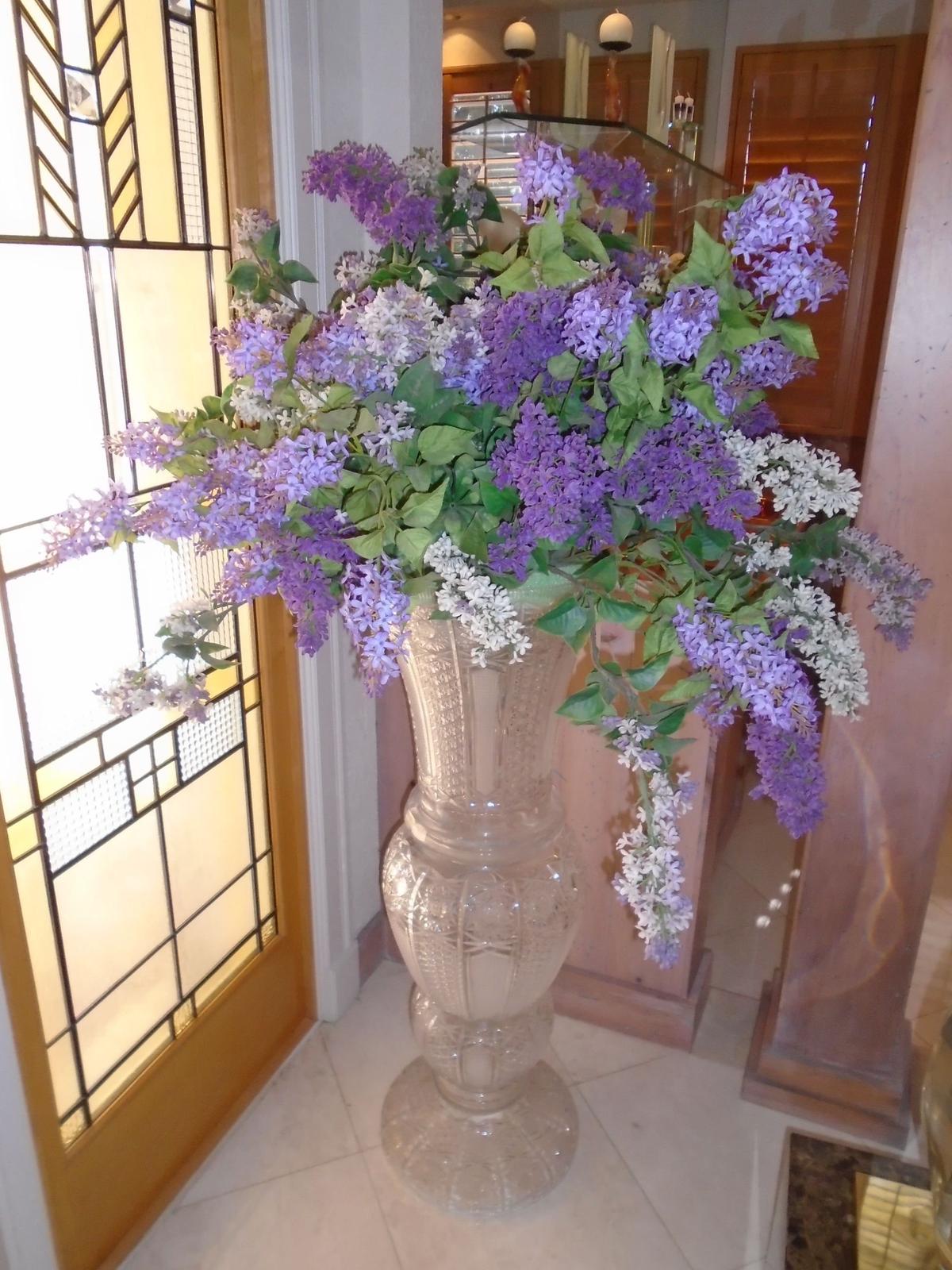 Large crystal Vase with purple and white silk flowers.