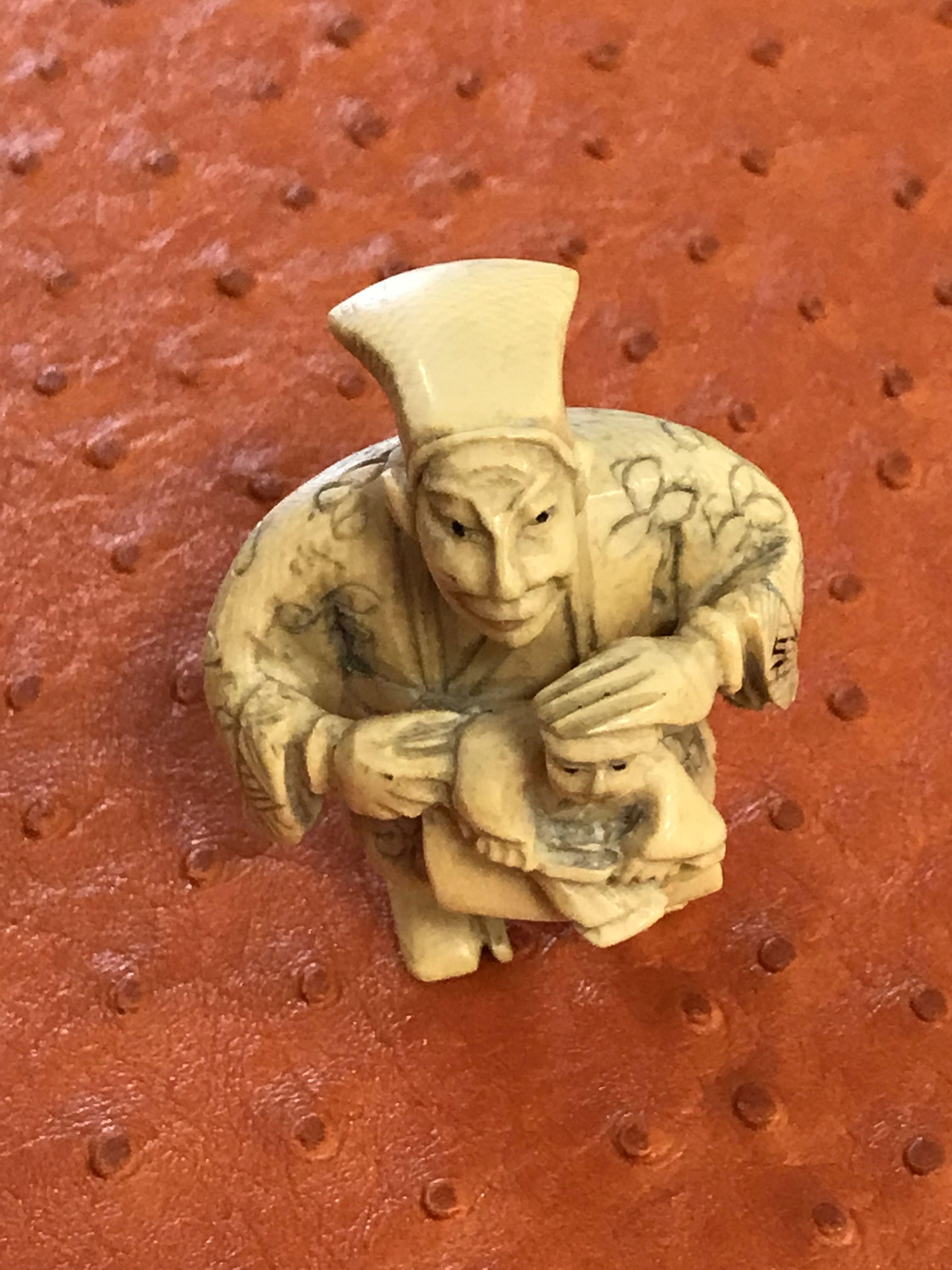 Antique Chinese timeless beautifully designed small ivory bone carved figurine of a man with child a