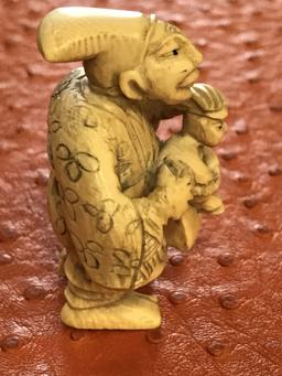 Antique Chinese timeless beautifully designed small ivory bone carved figurine of a man with child a