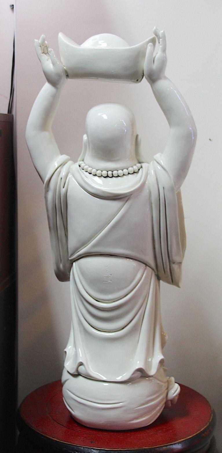 Blanc de chine Chinese porcelain happy standing buddha bringing money