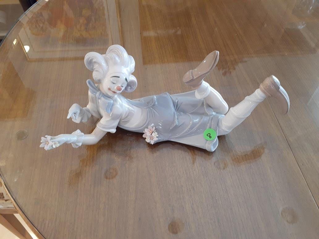 Lladro Clown laying down holding flowers