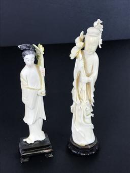 Male and Female carved statues on pedestals