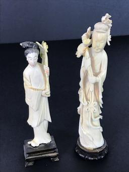 Male and Female carved statues on pedestals