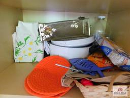 Cabinet and contents: tote bags, tablecloths, cleaning supplies