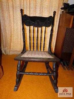 antique rocker with carved back