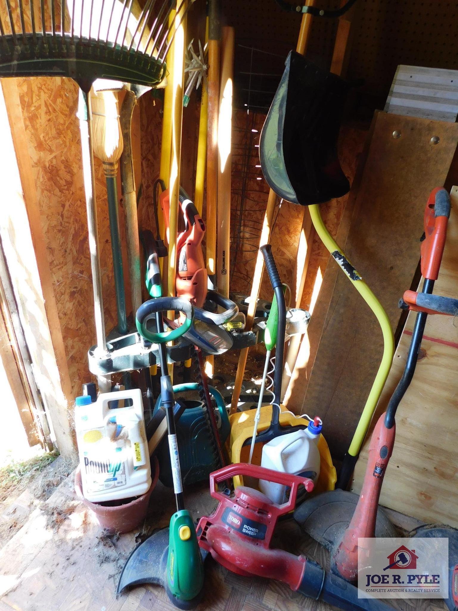 Lot of hand tools - electric weed eaters, brooms & car ramps