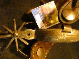 Pair of Hand forged and engraved Western Spurs. Little damage to the leather. Spurs work fine.