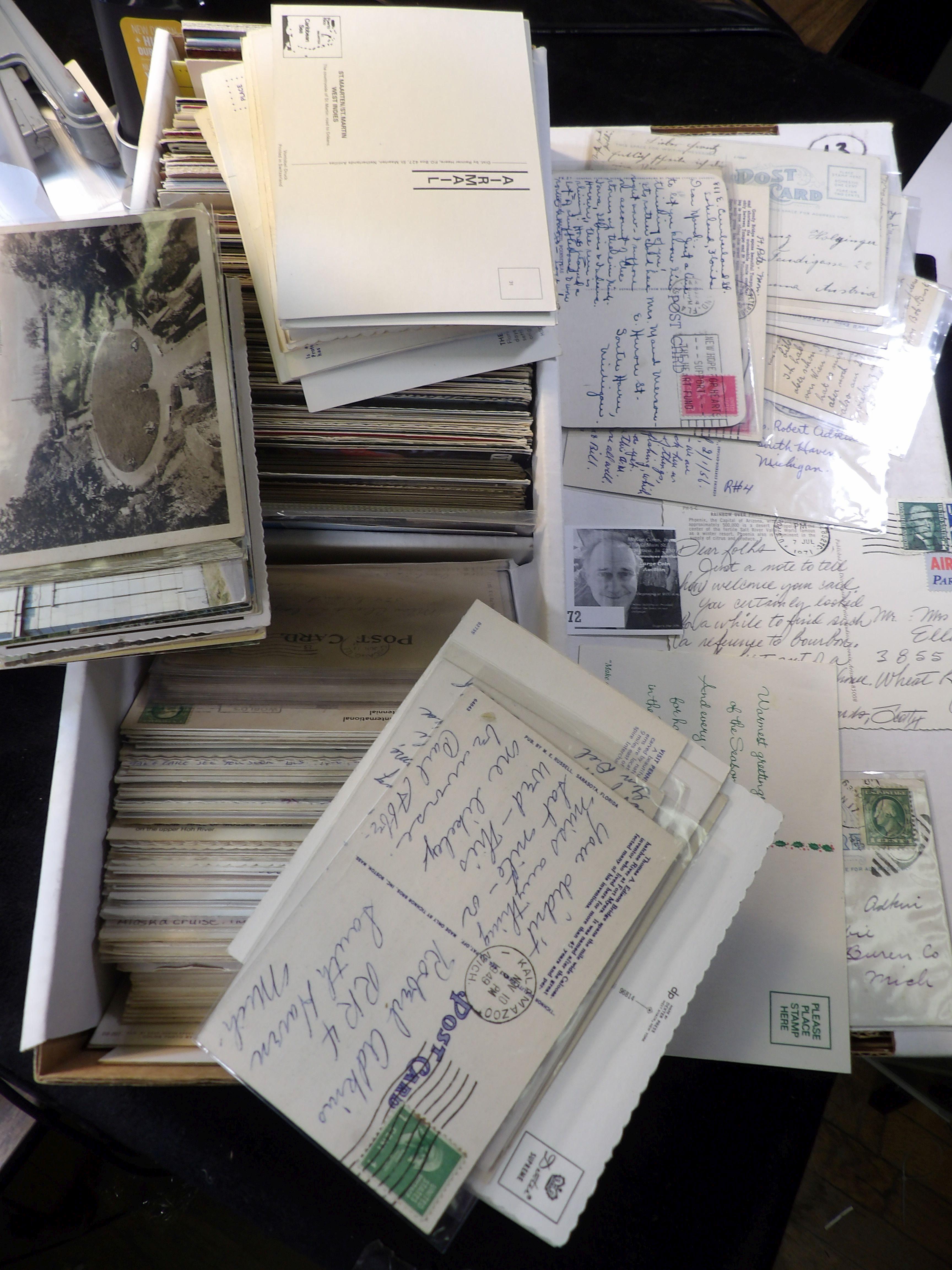 Approximately 900 Old Post Cards in a Postal Card box. Many have interesting Post Marks and cancelle