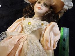 Lovely Brown-haired female Doll with lace Dress and hat, on stand. A little over 14" in height. Carr