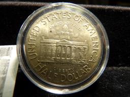 1846-1946 Iowa Silver Commemorative Half Dollar, Uncirculated and stored in a Cointain.