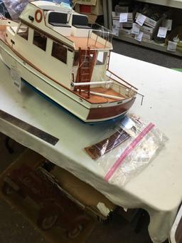 large remote controlled cabin boat with brass propeller shaft and chrome rotors needs repair in