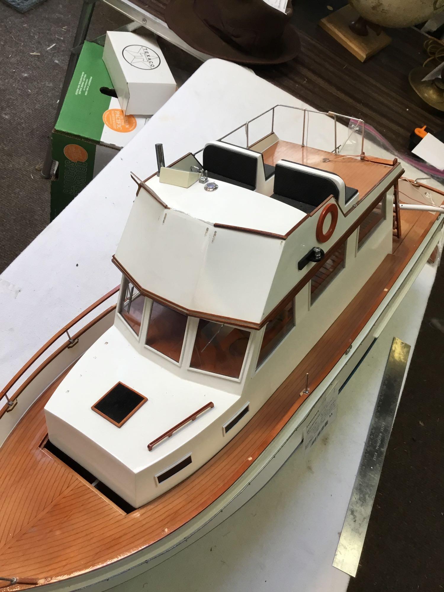 large remote controlled cabin boat with brass propeller shaft and chrome rotors needs repair in