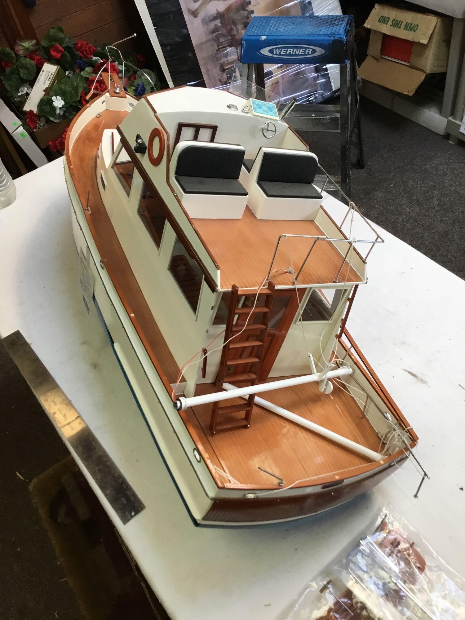large remote controlled cabin boat with brass propeller shaft and chrome rotors needs repair in