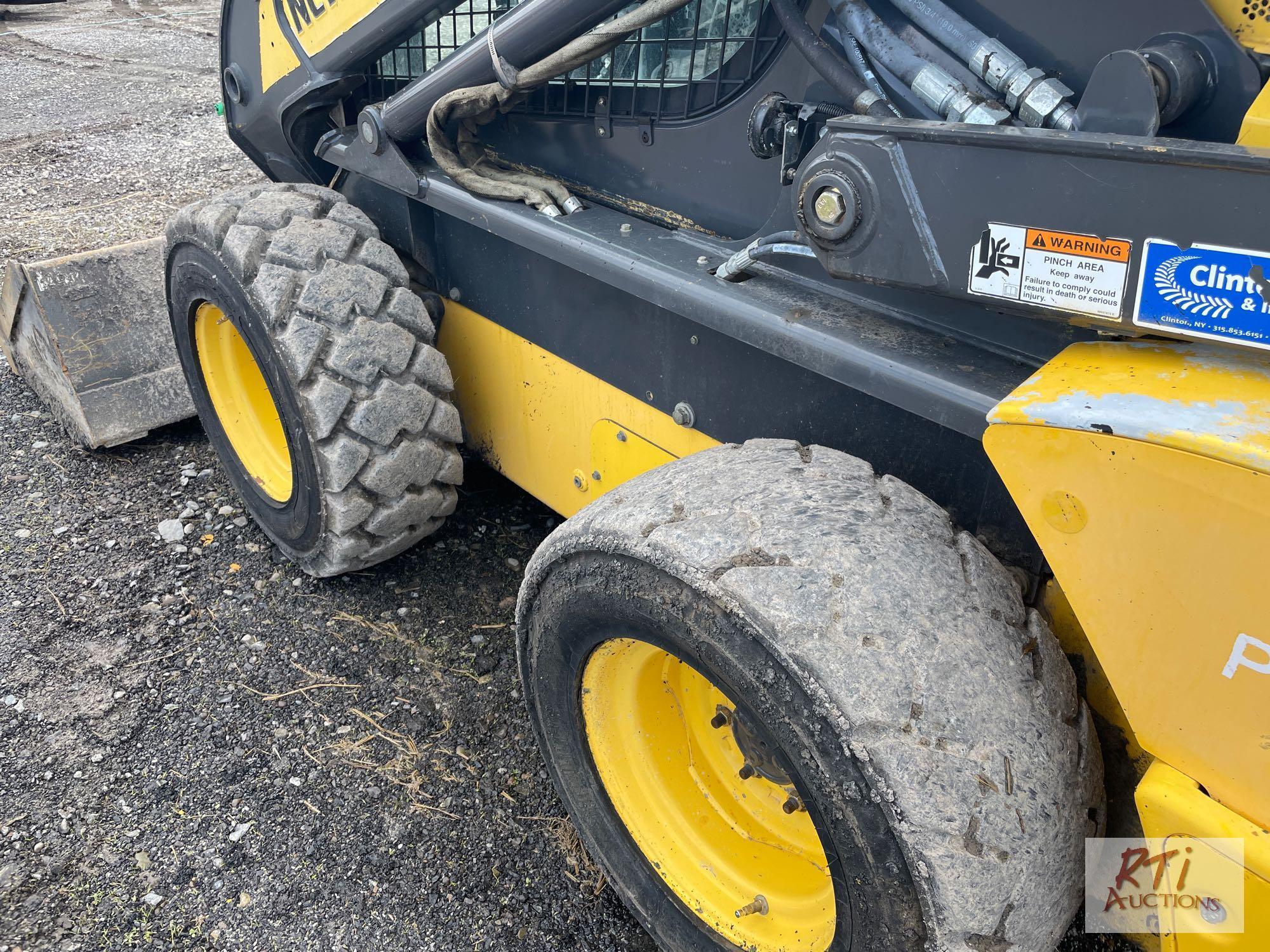 2013 New Holland L225 skid loader, GP bucket, cab (missing door) power wedges, heat, AC, hand and