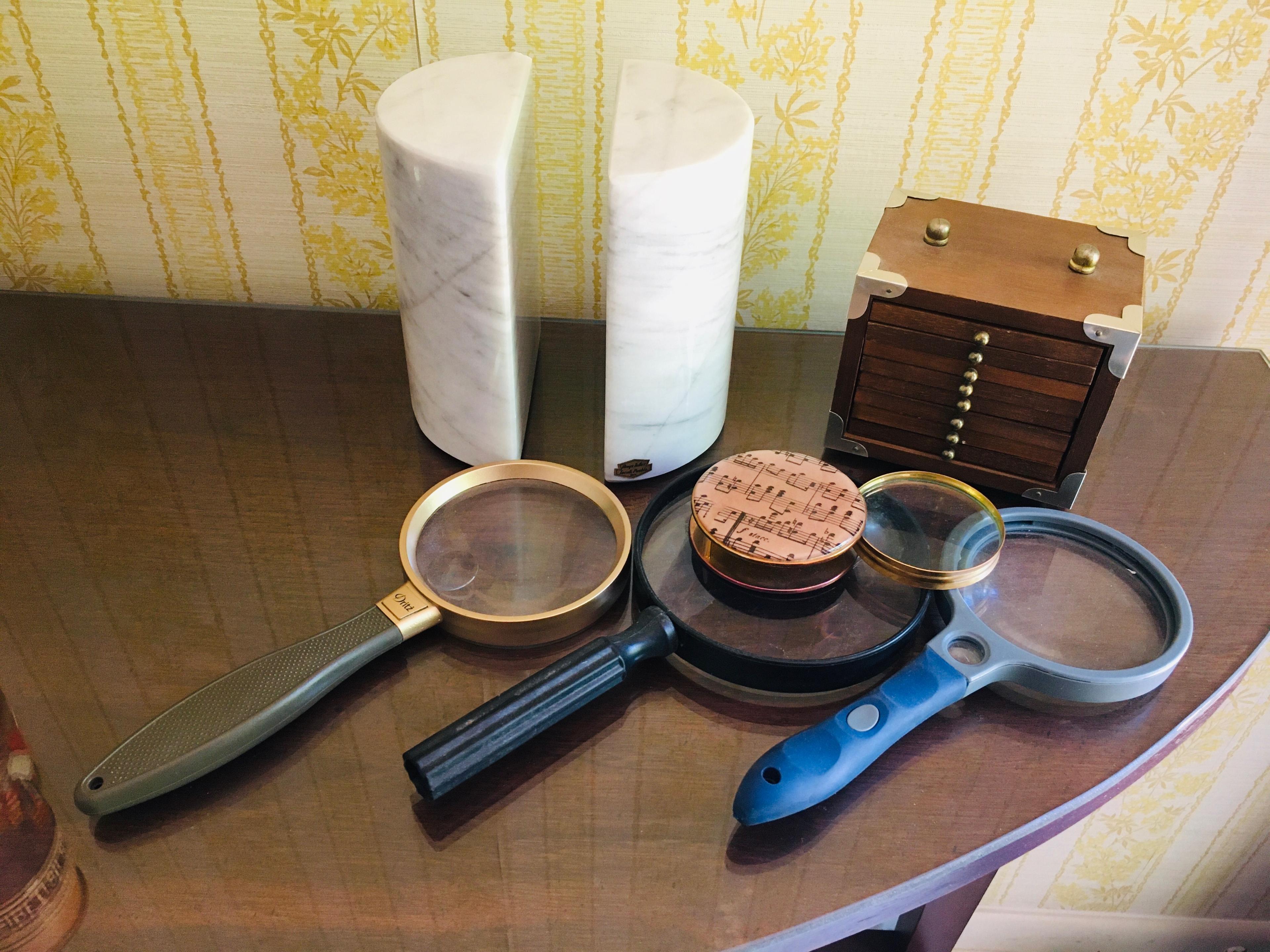 Marble book end magnifying glasses and stack of coasters in wooden case