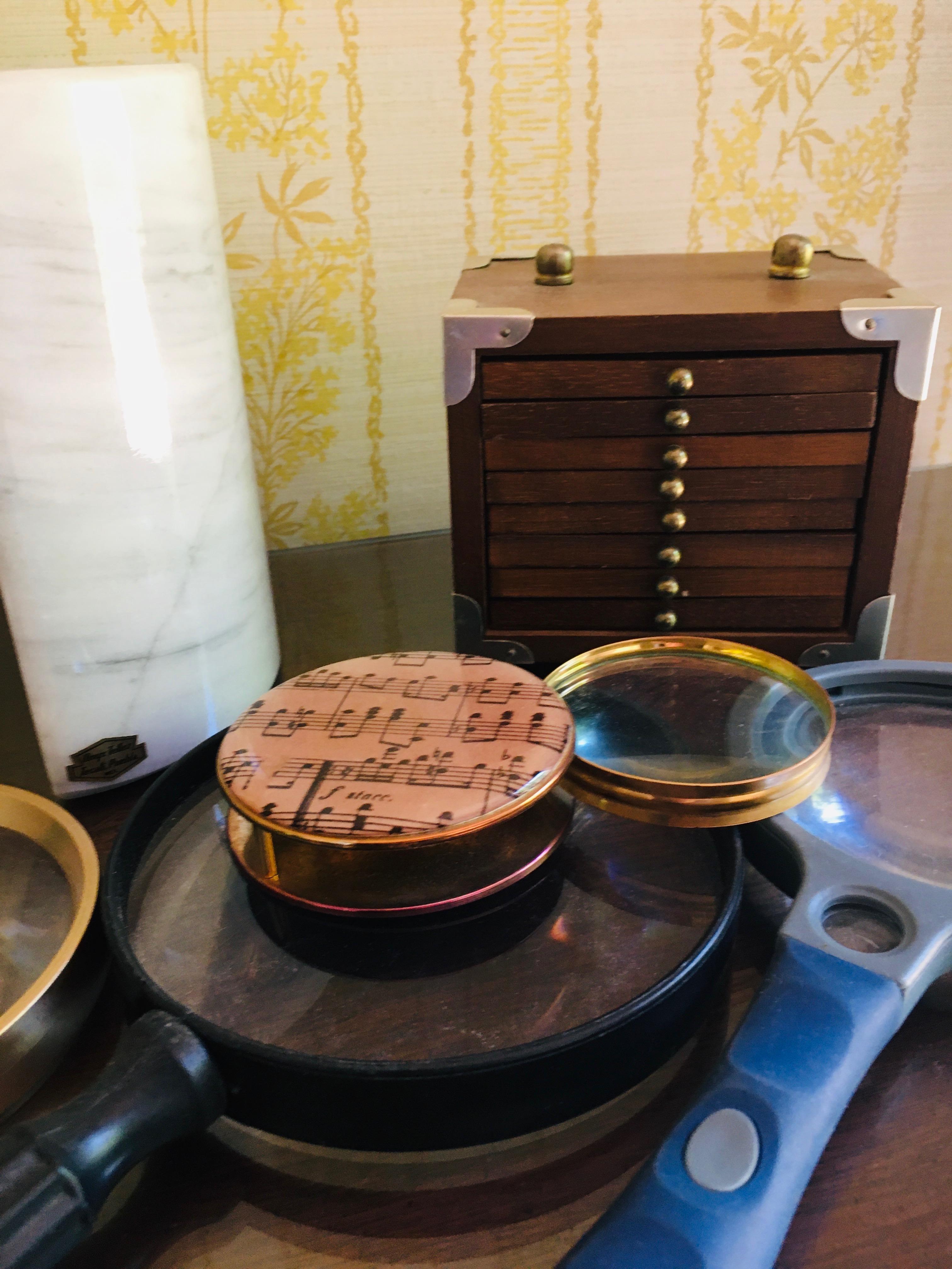 Marble book end magnifying glasses and stack of coasters in wooden case