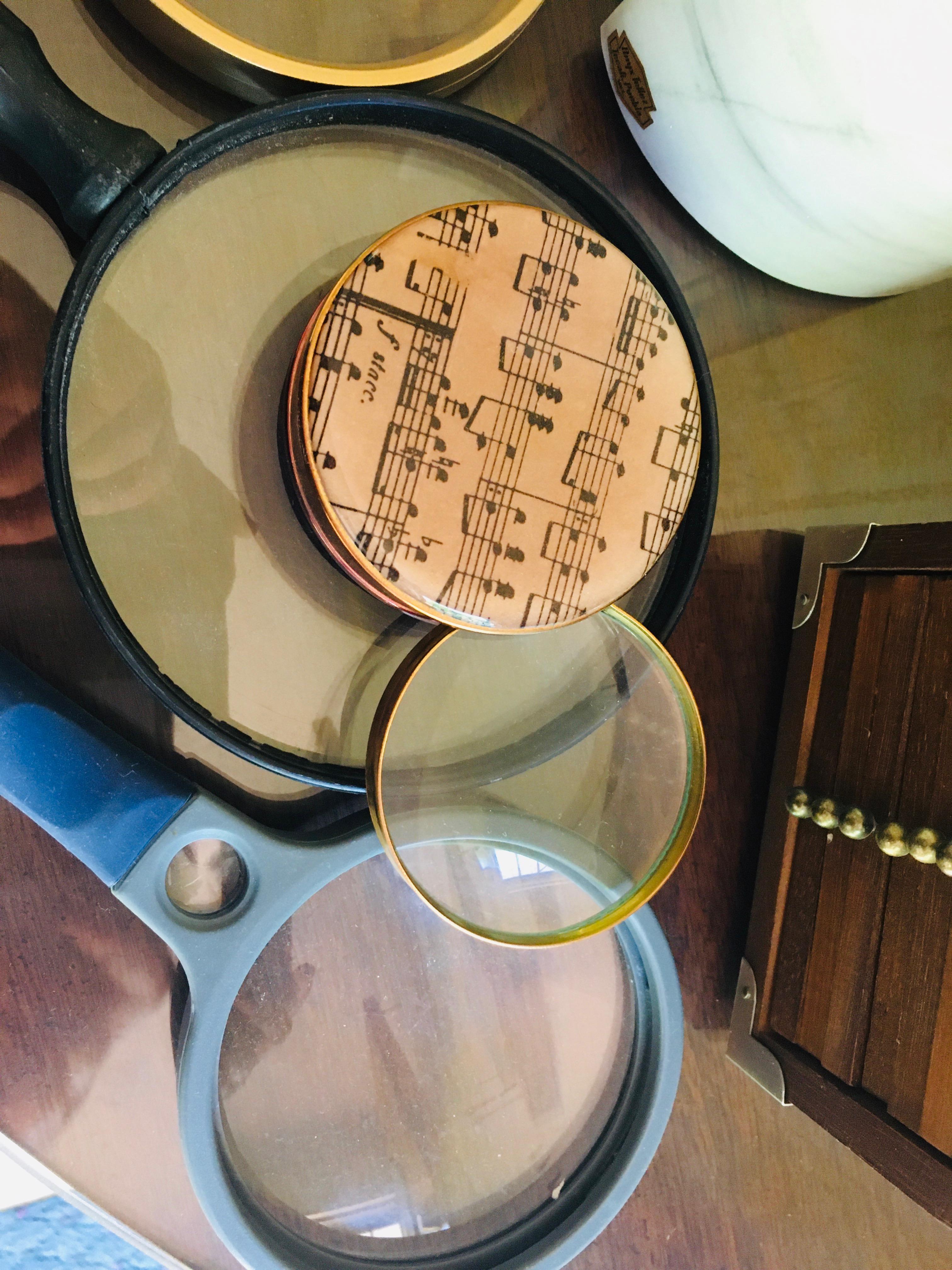 Marble book end magnifying glasses and stack of coasters in wooden case