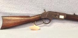 Model 1873 32 cal Winchester having original slide plate and octagon barrel  serial number 319577B