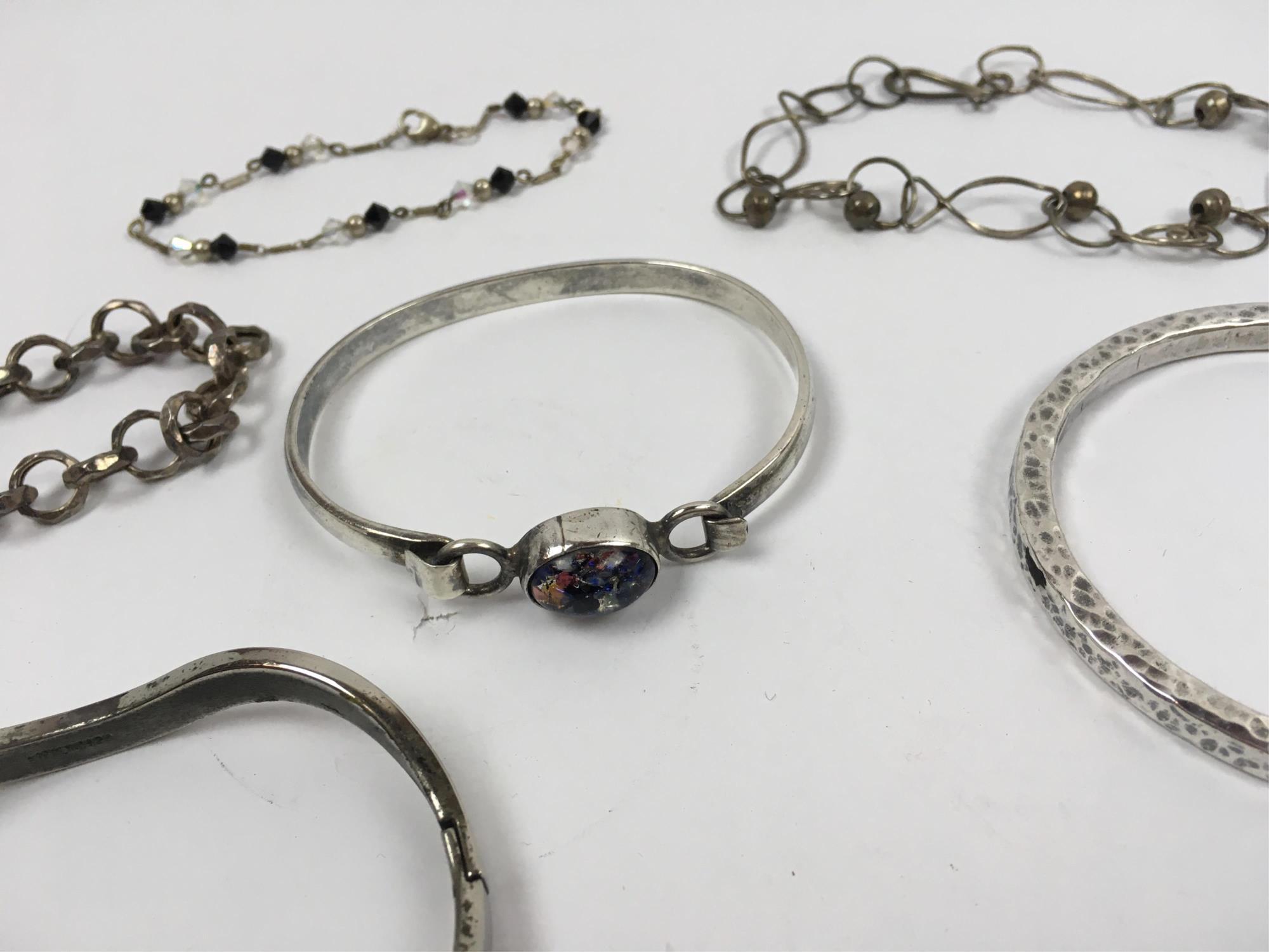 NINETEEN STERLING SILVER BRACELETS