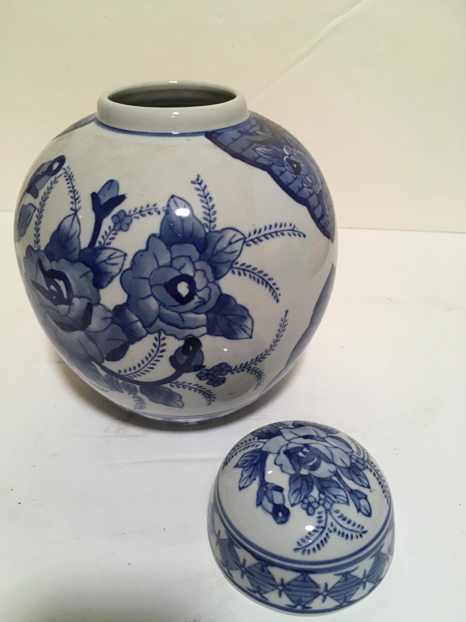 LIDDED BLUE AND WHITE ASIAN JAR W FLOWERS