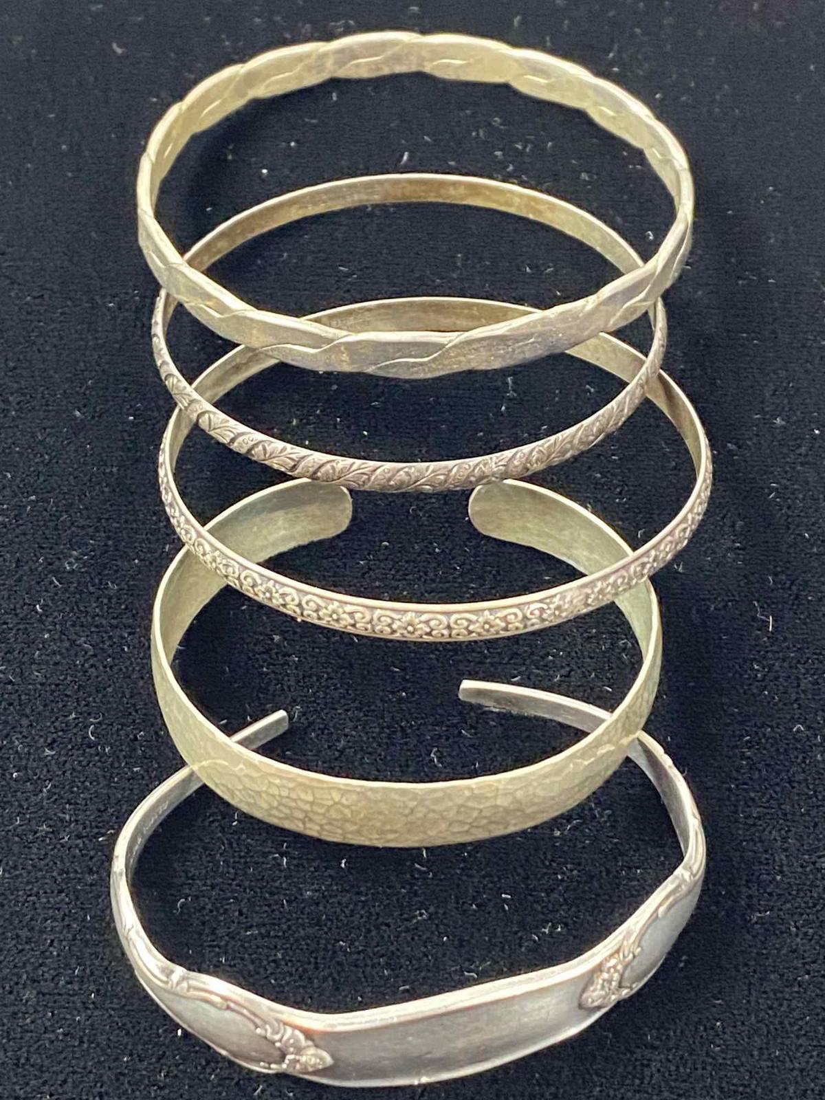 FOUR STERLING SILVER BRACELETS