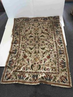 FLORAL RUG WITH TANS REDS AND BLUES