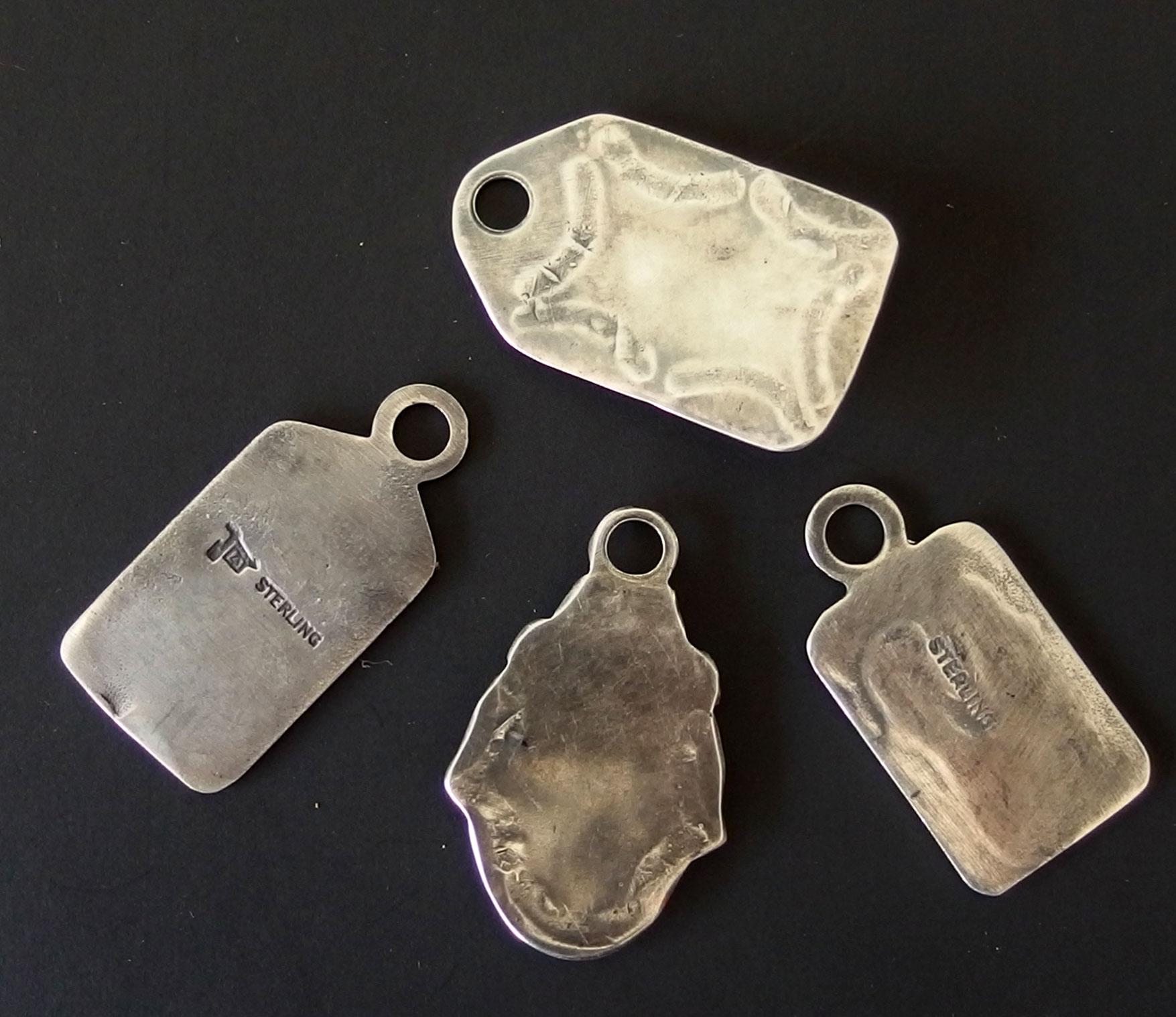 FOUR (4) VINTAGE NAVAJO STERLING PENDANTS