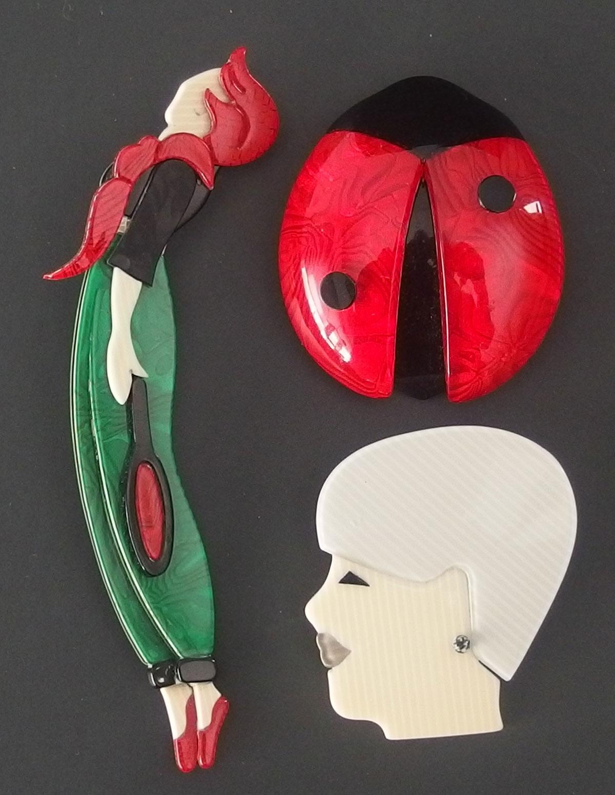 THREE (3) SIGNED LEAH STEIN PLASTIC BROOCHES