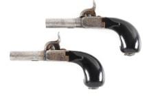 (A) PAIR OF TEARDROP-CASED BELGIAN PERCUSSION MUFF PISTOLS.