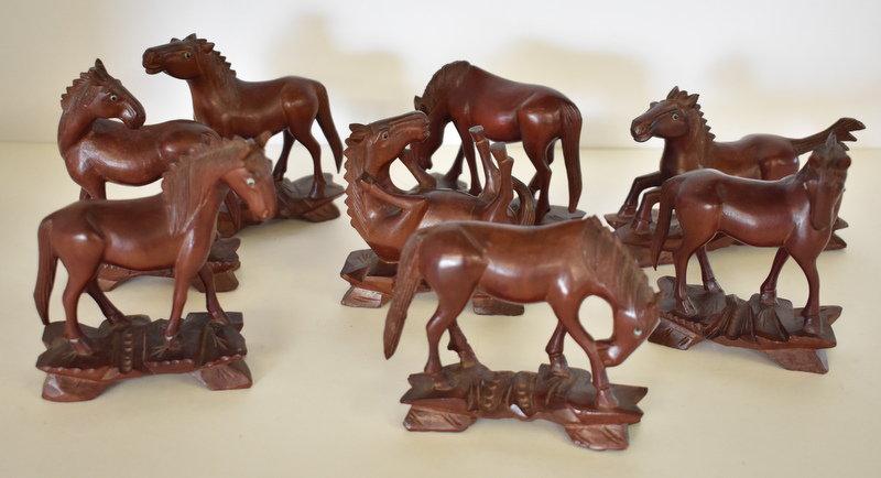 EIGHT HAND-CARVED WOODEN HORSES