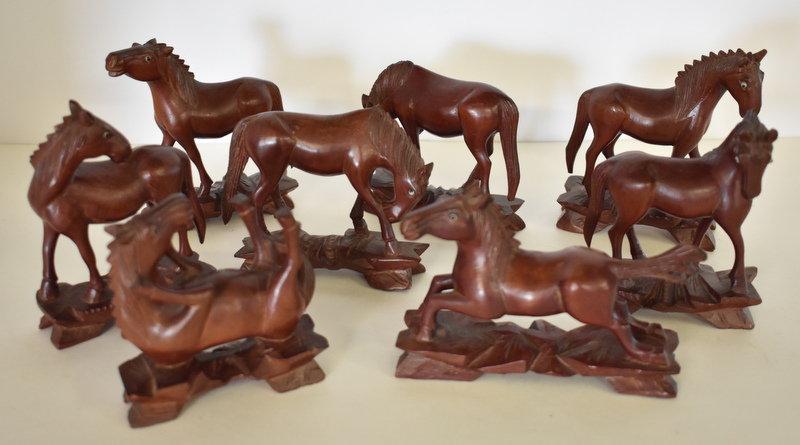 EIGHT HAND-CARVED WOODEN HORSES