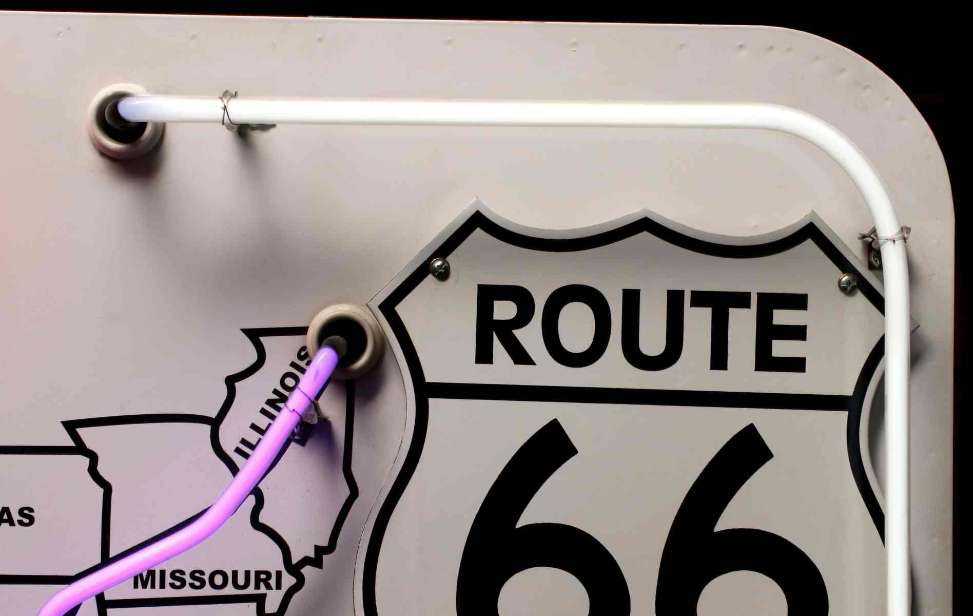 A ROUTE 66 PORCELAIN SIGN WITH NEON