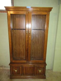 OAK FINISH GUN CABINET. GLASS RETAINERS NEED REPAIRED