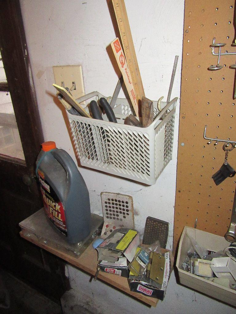 ASSORTMENT OF HAND TOOLS AND HARDWARE ON WALL