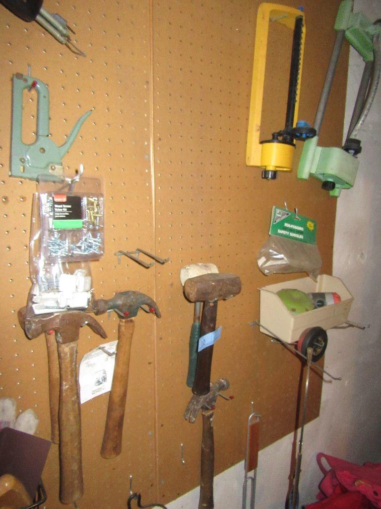ASSORTMENT OF HAND TOOLS AND HARDWARE ON WALL