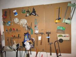 ASSORTMENT OF HAND TOOLS AND HARDWARE ON WALL