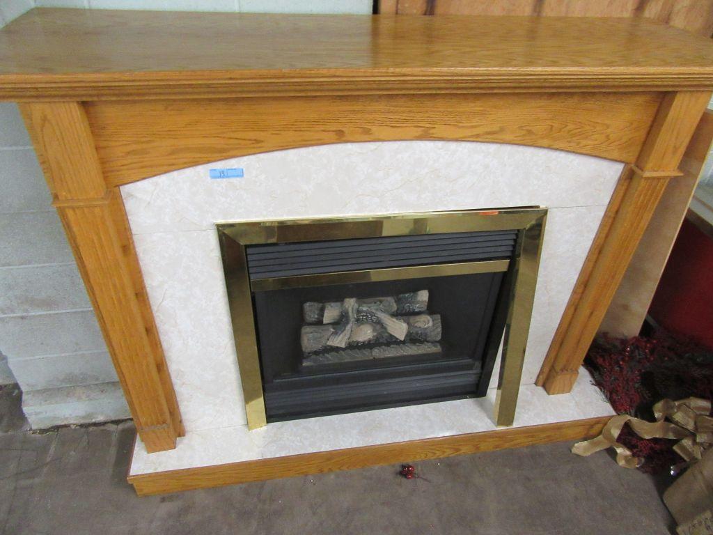 OAK MANTEL WITH MAJESTIC GAS FIREPLACE INSERT. IT IS MISSING ONE BOARD ON T