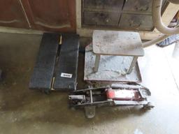 four-wheel dolly, mechanic stool, and floor jack. floor jack is missing handle.