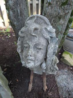 concrete face statue.