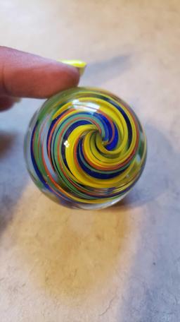 handmade yellow, green, blue, and orange swirl marble signed FES 01. 1-3/4 in