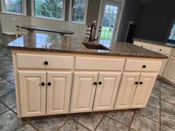 granite top island with sink and garbage disposal. approximately 6 ft by 3 ft....Buyer is responsibl