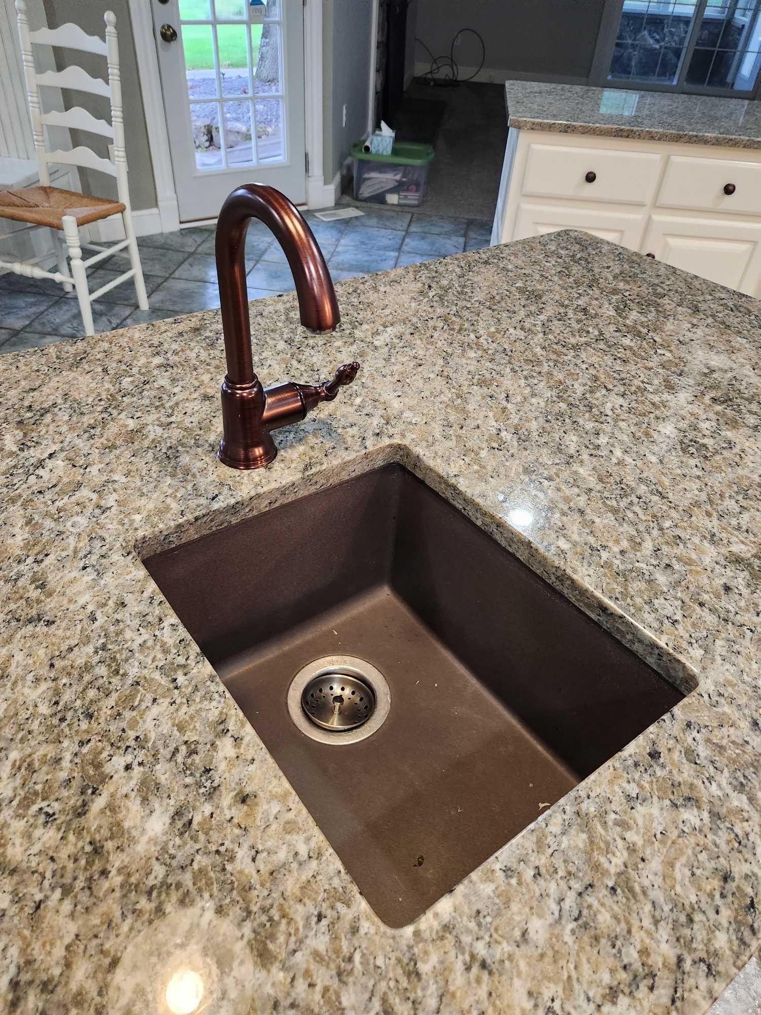 granite top island with sink and garbage disposal. approximately 6 ft by 3 ft....Buyer is responsibl