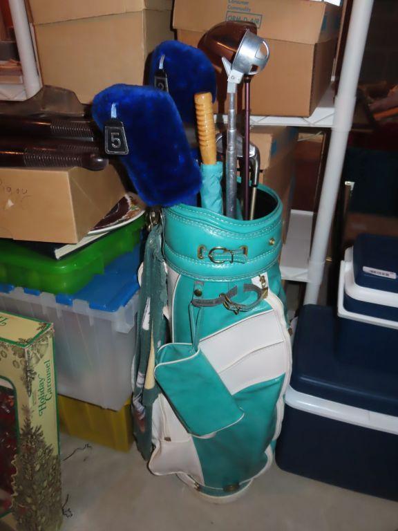 Green golf bag with clubs