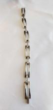 Silver colored bracelet with small clear gemstones marked 925....DESCRIPTION PROVIDED BY SELLER.