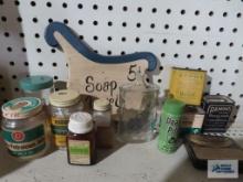 Lot of vintage tins and bottles, soap and towels wall hanging