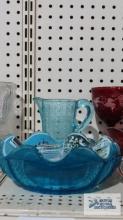 Blue glass pitcher, bowl, and Walt Disney World frilled advertising plates